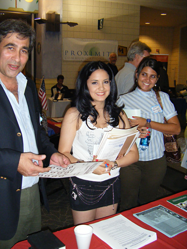 Delegate, Marianella Rodriguez, enjoys a conversation with Business owners at the Expo